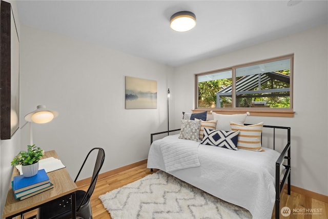 bedroom featuring wood finished floors and baseboards