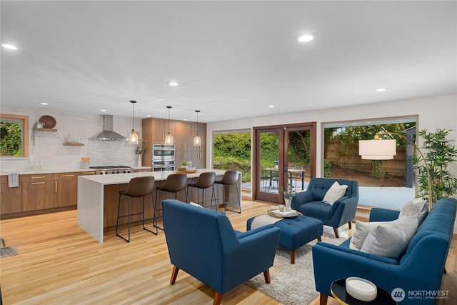 living room featuring light wood finished floors and recessed lighting