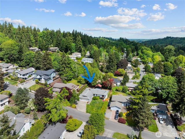 aerial perspective of suburban area featuring a heavily wooded area