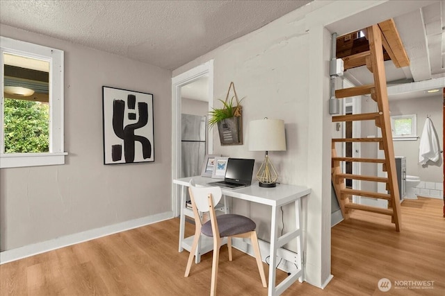 508 N 95th St, Seattle, WA 98103 - office featuring light wood-type flooring, a textured ceiling, and baseboards