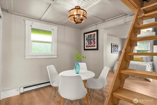 508 N 95th St, Seattle, WA 98103 - dining space featuring a baseboard radiator, wood finished floors, stairs, a chandelier, and wooden ceiling with exposed beams