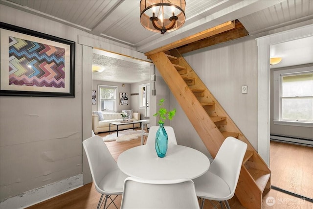 508 N 95th St, Seattle, WA 98103 - dining room featuring stairs, wood finished floors, and a baseboard heating unit