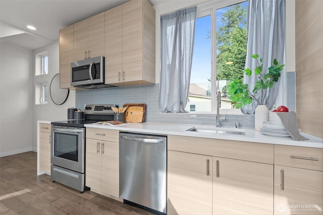 1405 Martin Luther King Jr Way, Seattle, WA 98122 - kitchen with appliances with stainless steel finishes, modern cabinets, a sink, baseboards, and light countertops