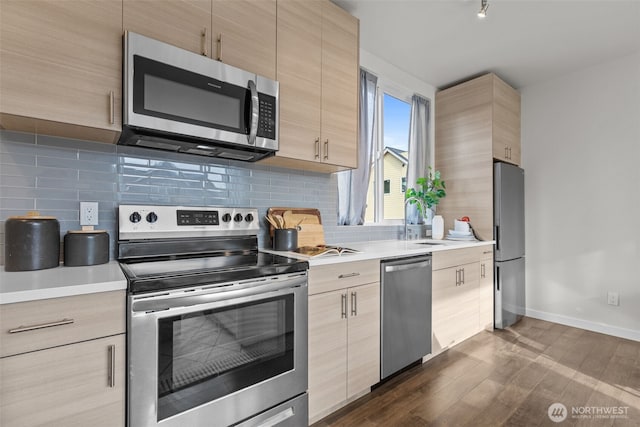 1405 Martin Luther King Jr Way, Seattle, WA 98122 - kitchen with stainless steel appliances, light brown cabinetry, a sink, and light countertops