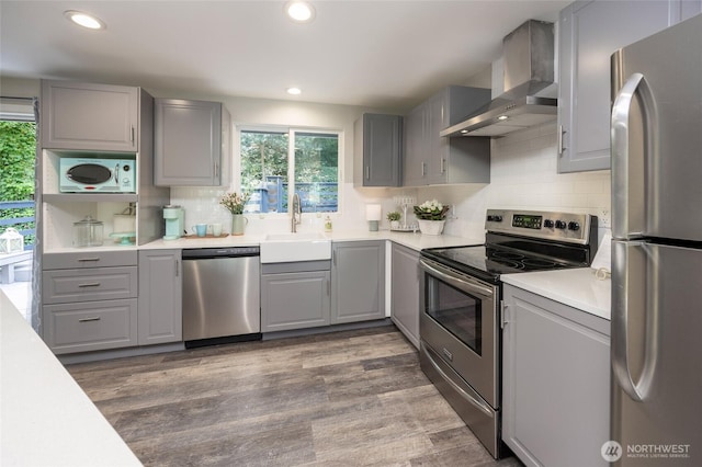 24222 92nd Ave W, Edmonds, WA 98020 - kitchen with appliances with stainless steel finishes, gray cabinets, wall chimney exhaust hood, backsplash, and recessed lighting