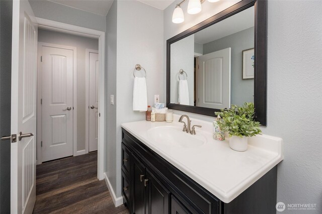 24222 92nd Ave W, Edmonds, WA 98020 - bathroom featuring vanity, wood finished floors, and baseboards