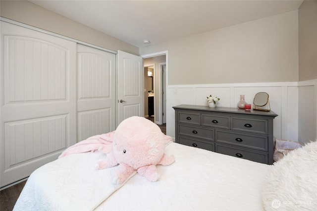 24222 92nd Ave W, Edmonds, WA 98020 - bedroom with a wainscoted wall, a closet, dark wood-style floors, and a decorative wall