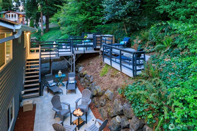 24222 92nd Ave W, Edmonds, WA 98020 - view of patio featuring stairs, an outdoor fire pit, a deck, and view of wooded area