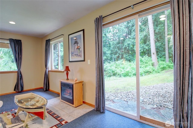 362 N Sunrise Blvd, Camano Island, WA 98282 - doorway to outside with plenty of natural light, baseboards, light tile patterned floors, recessed lighting, and a glass covered fireplace