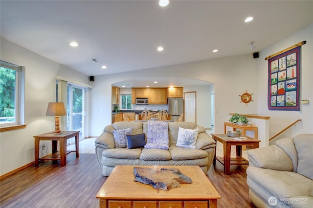 362 N Sunrise Blvd, Camano Island, WA 98282 - living room featuring arched walkways, recessed lighting, wood finished floors, plenty of natural light, and baseboards