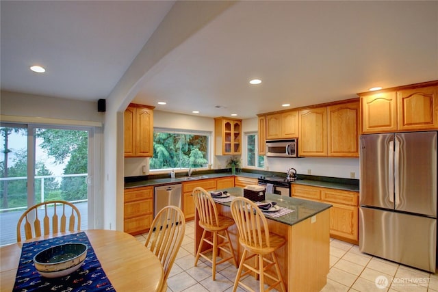 362 N Sunrise Blvd, Camano Island, WA 98282 - kitchen with appliances with stainless steel finishes, a sink, light tile patterned flooring, recessed lighting, and glass insert cabinets