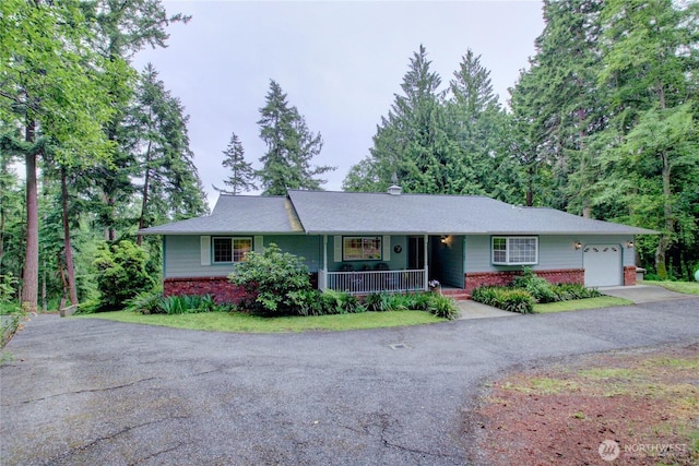 362 N Sunrise Blvd, Camano Island, WA 98282 - ranch-style home featuring brick siding, a porch, driveway, and a garage