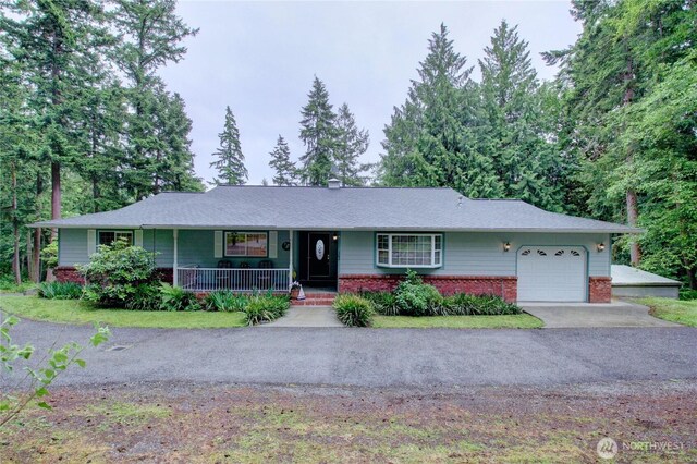 362 N Sunrise Blvd, Camano Island, WA 98282 - ranch-style home featuring a garage, a porch, brick siding, asphalt driveway, and a chimney