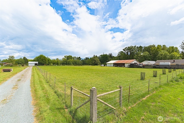view of yard with a view of countryside and driveway