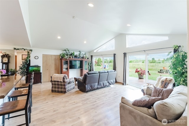 living room with lofted ceiling, light wood finished floors, and recessed lighting
