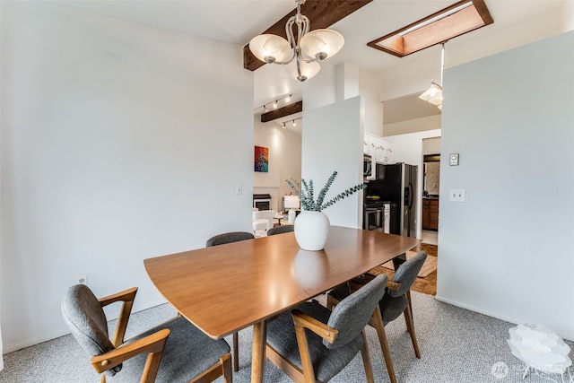 135 N 46th St Unit 402, Seattle, WA 98103 - dining room with light colored carpet, a chandelier, and baseboards