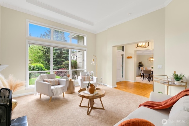 23322 SE 26th Pl, Sammamish, WA 98075 - living area featuring crown molding, a chandelier, healthy amount of natural light, light carpet, and a towering ceiling