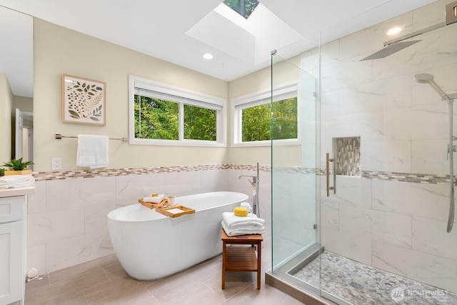 23322 SE 26th Pl, Sammamish, WA 98075 - full bath with a skylight, a stall shower, tile walls, a soaking tub, and vanity