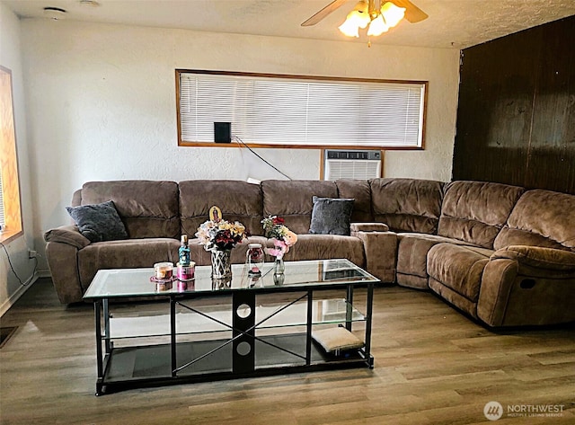 953 E Ash St, Othello, WA 99344 - living room with wood finished floors, ceiling fan, a textured wall, baseboards, and cooling unit