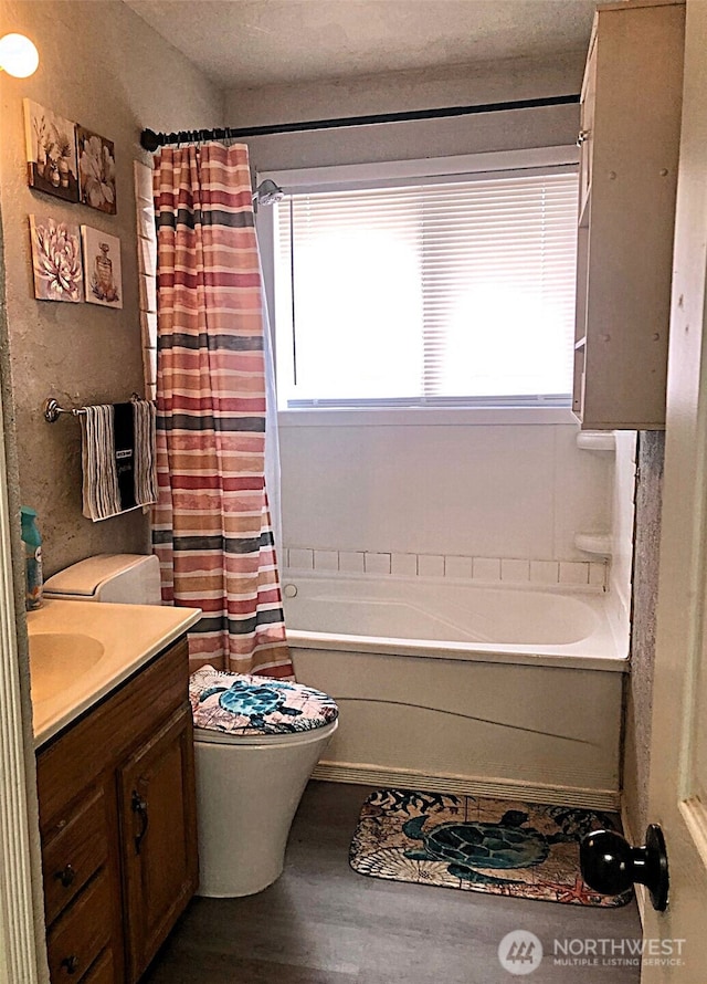 953 E Ash St, Othello, WA 99344 - full bathroom featuring healthy amount of natural light, wood finished floors, vanity, and toilet