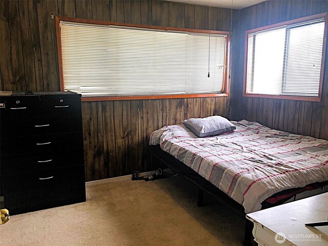 953 E Ash St, Othello, WA 99344 - bedroom with wooden walls and light colored carpet
