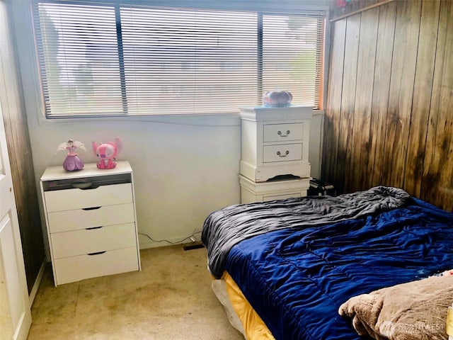 953 E Ash St, Othello, WA 99344 - bedroom with light colored carpet, multiple windows, and wood walls