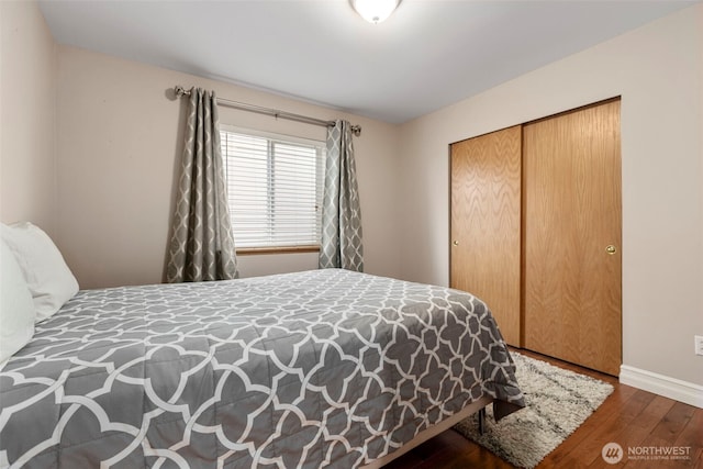 bedroom featuring wood-type flooring, baseboards, and a closet