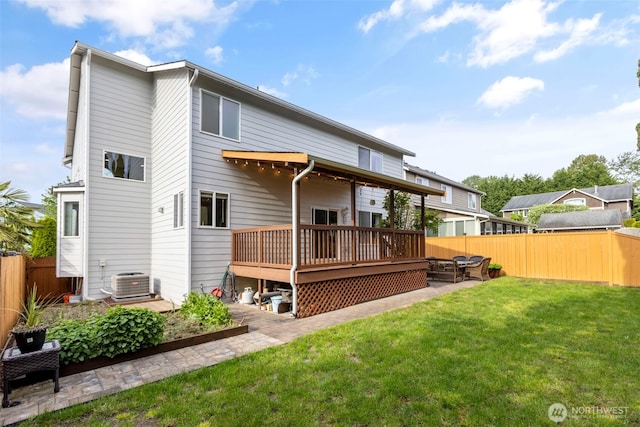 rear view of property with a wooden deck, central air condition unit, and a patio area