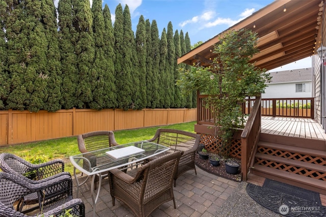 view of patio with outdoor dining area and a deck