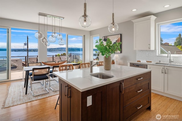 815 33rd Ave S, Seattle, WA 98144 - kitchen featuring a sink, light wood-style flooring, white cabinetry, tasteful backsplash, and recessed lighting
