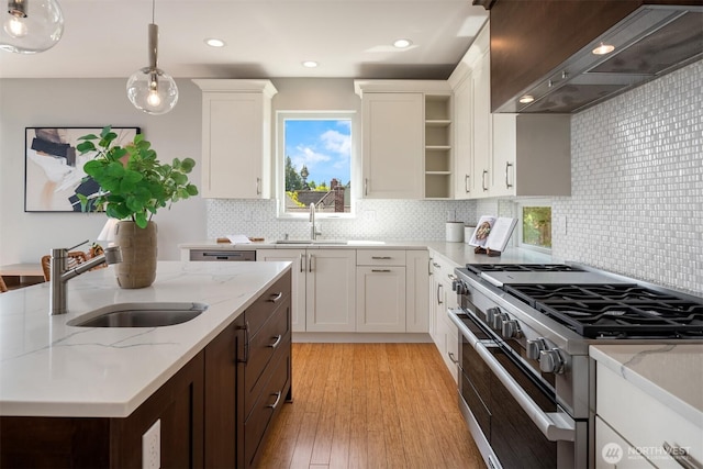815 33rd Ave S, Seattle, WA 98144 - kitchen with high end stove, a sink, wall chimney exhaust hood, open shelves, and plenty of natural light