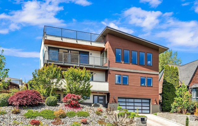 815 33rd Ave S, Seattle, WA 98144 - view of front of house with a balcony, an attached garage, and concrete driveway