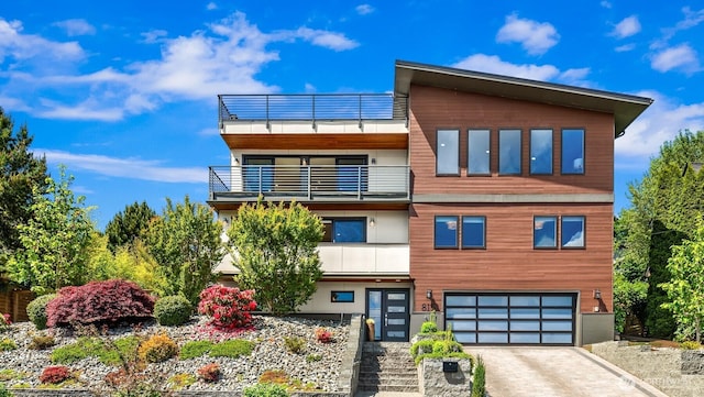 815 33rd Ave S, Seattle, WA 98144 - view of front of house featuring a balcony, a garage, and driveway