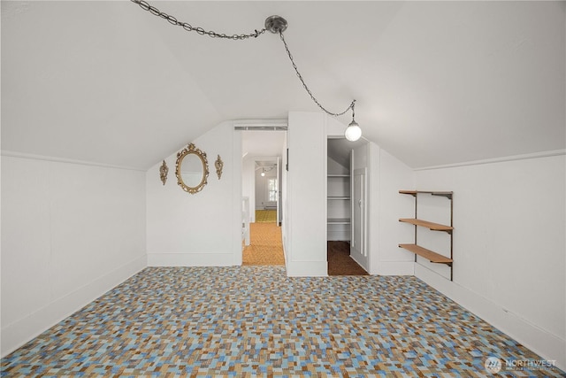 bonus room featuring vaulted ceiling and carpet floors