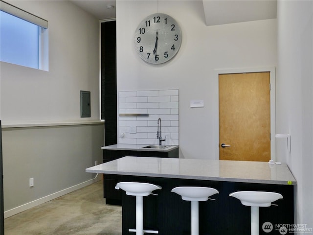 dining room with electric panel and baseboards