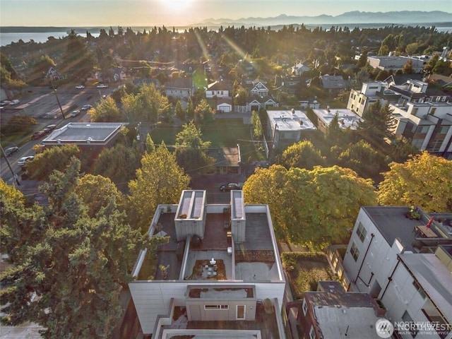 aerial view of property and surrounding area featuring nearby suburban area