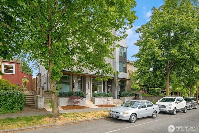 view of front of home featuring stairway