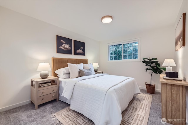 carpeted bedroom featuring baseboards
