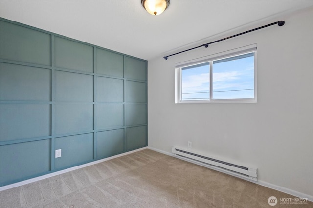 unfurnished bedroom with baseboard heating, carpet floors, and baseboards
