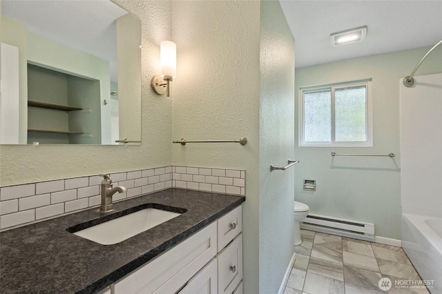 bathroom with a baseboard radiator, tasteful backsplash, toilet, baseboards, and vanity