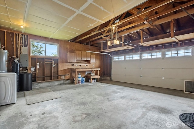 garage with a garage door opener and water heater