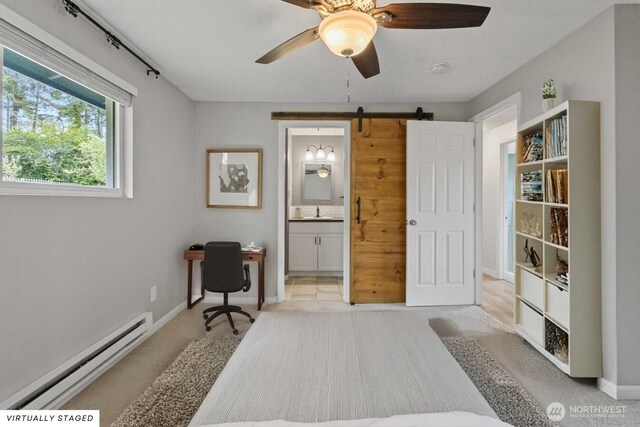 1310 Swantown Rd, Oak Harbor, WA 98277 - bedroom featuring baseboard heating, a barn door, ensuite bathroom, a sink, and baseboards