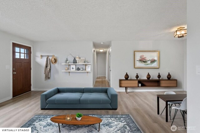 1310 Swantown Rd, Oak Harbor, WA 98277 - living room featuring wood finished floors, a textured ceiling, and baseboards