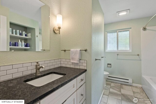 1310 Swantown Rd, Oak Harbor, WA 98277 - full bath with a baseboard radiator, vanity, toilet, decorative backsplash, and marble finish floors