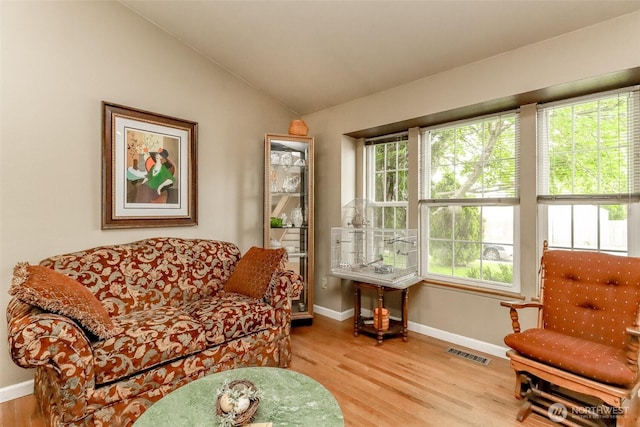 103 Schmid St, Enumclaw, WA 98022 - sitting room with healthy amount of natural light, wood finished floors, baseboards, and vaulted ceiling