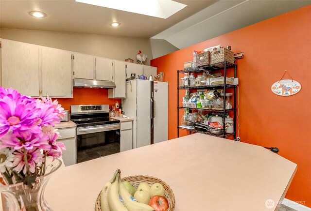 103 Schmid St, Enumclaw, WA 98022 - kitchen featuring electric range, freestanding refrigerator, a skylight, vaulted ceiling, and under cabinet range hood