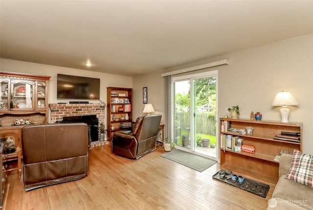 103 Schmid St, Enumclaw, WA 98022 - living room featuring hardwood / wood-style flooring and a brick fireplace