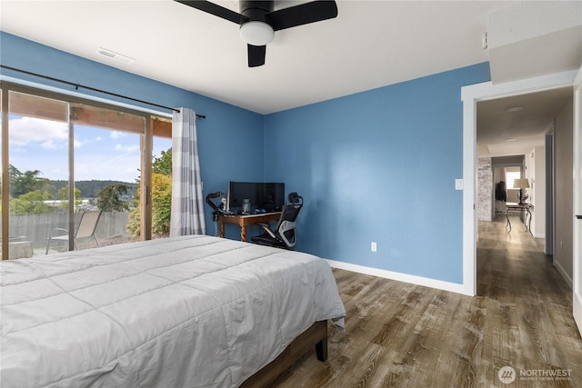 bedroom featuring wood finished floors, baseboards, and a ceiling fan
