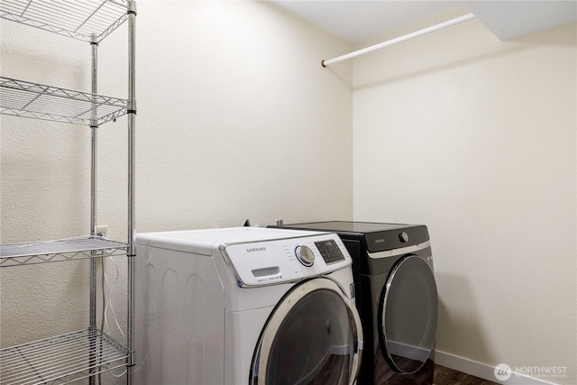 washroom with independent washer and dryer and wood finished floors