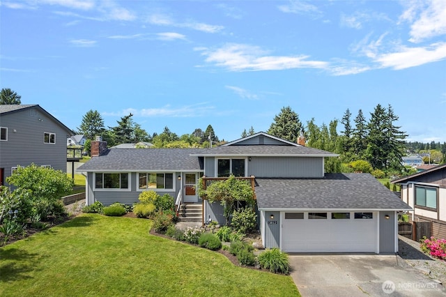 3812 R Ave, Anacortes, WA 98221 - tri-level home with roof with shingles, a chimney, concrete driveway, and an attached garage